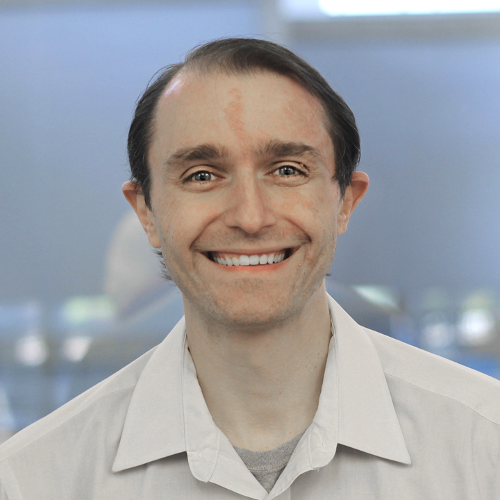 A headshot of Daniel Sabo wearing a white collared shirt.